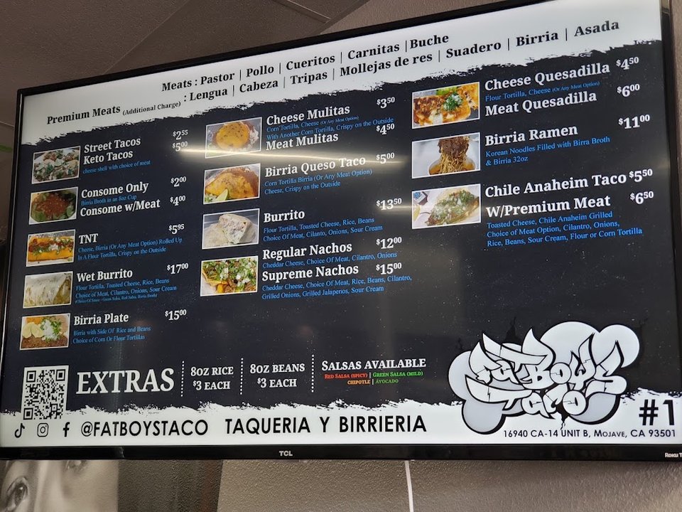 Menu board with tacos and small plates.